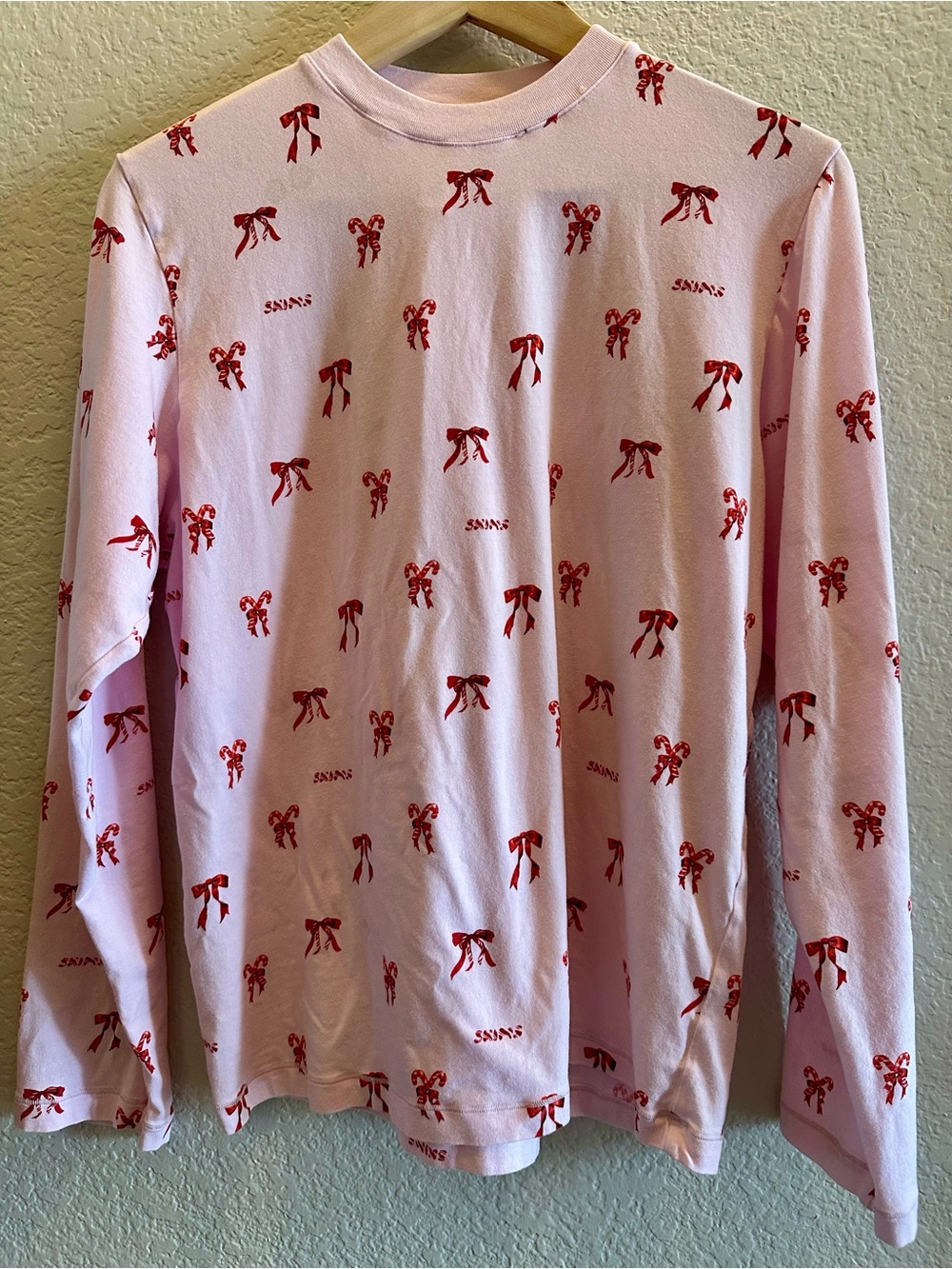 SKIMS Pink Long-Sleeve Pajama Top with Red Bow & Candy Cane Print